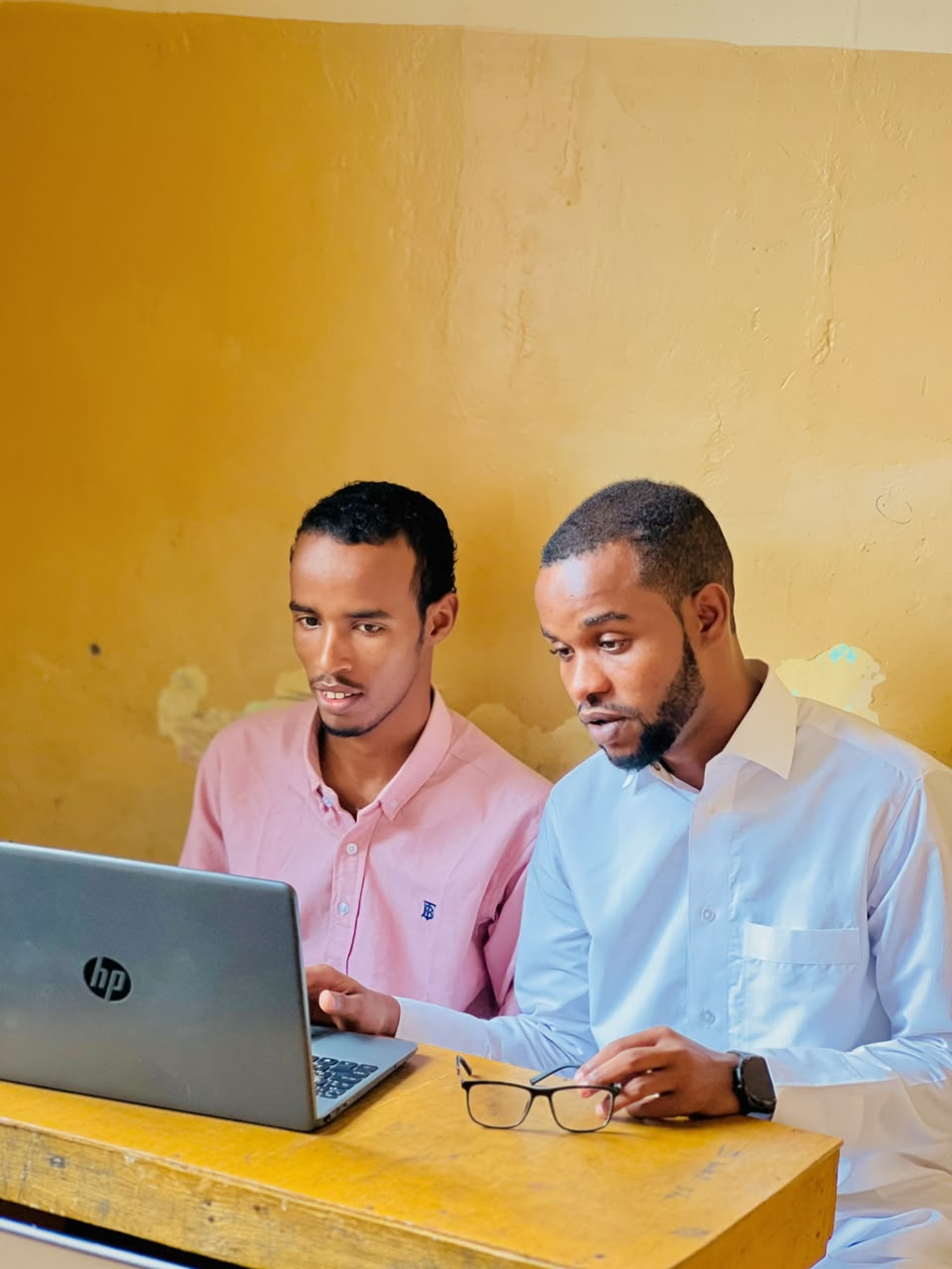 Two students learning on a laptop