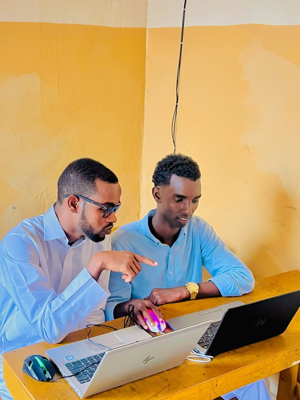 Instructor and students working on computers at SAFCE