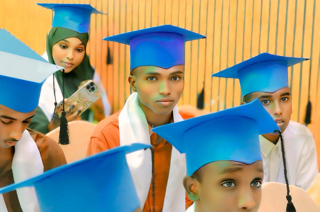 Students wearing blue graduation caps